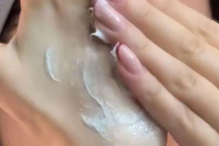 Woman applying Icelandic Volcano body scrub on hands for smooth skin