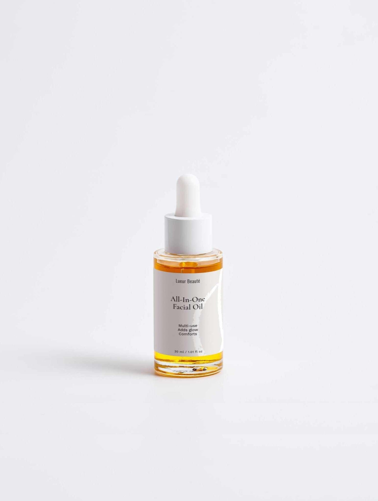 Bottle of 'All-In-One Facial Oil' on a white background