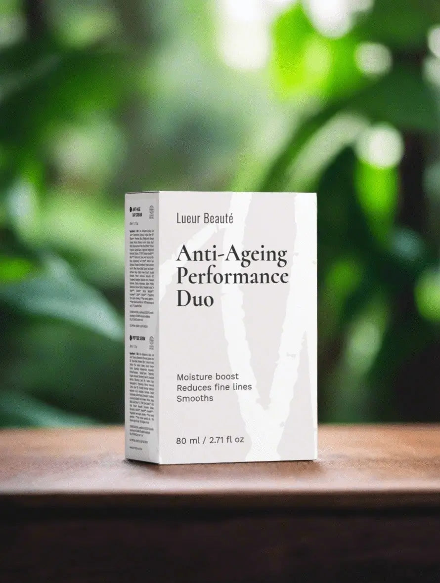 Anti-Ageing Performance Duo packaging on a wooden surface with a blurred green leafy background