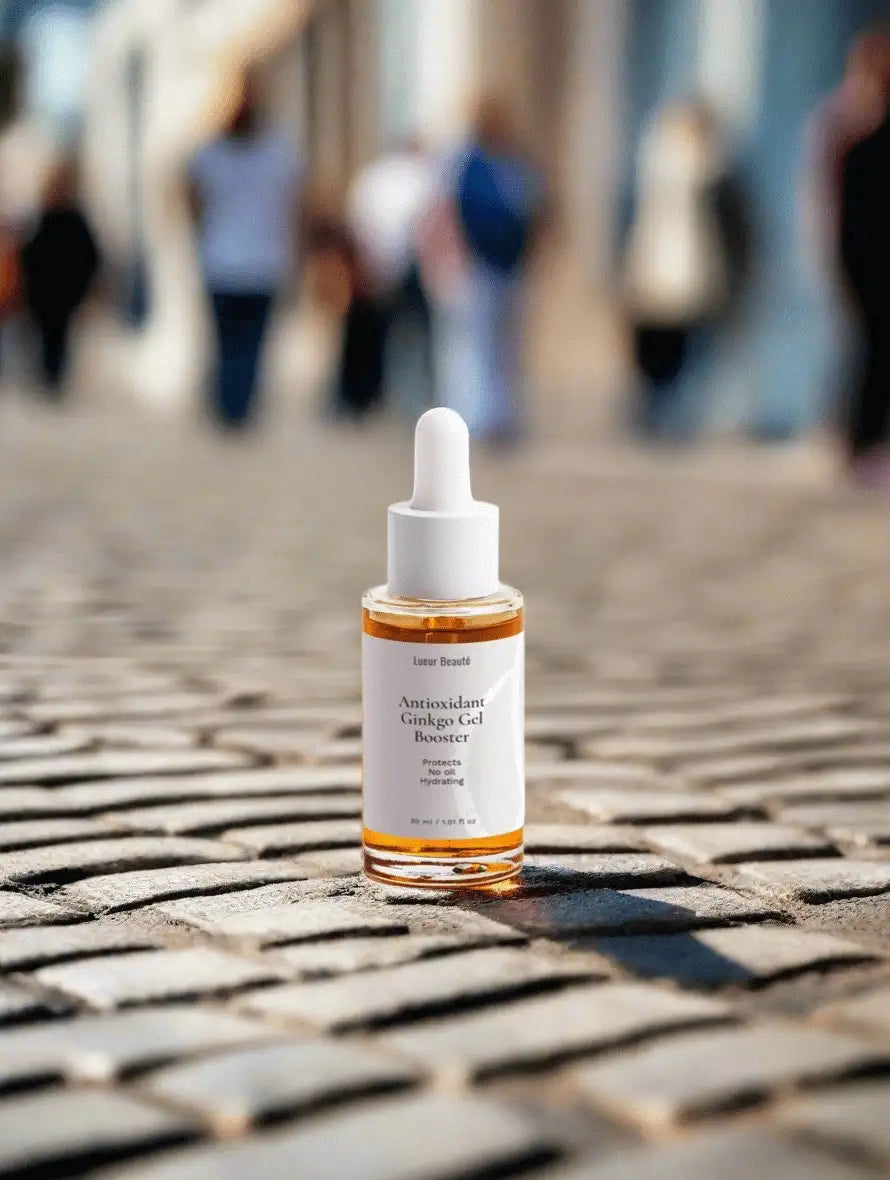 Lueur Beauté Antioxidant Ginkgo Gel Booster placed on cobblestone street with blurred people in background