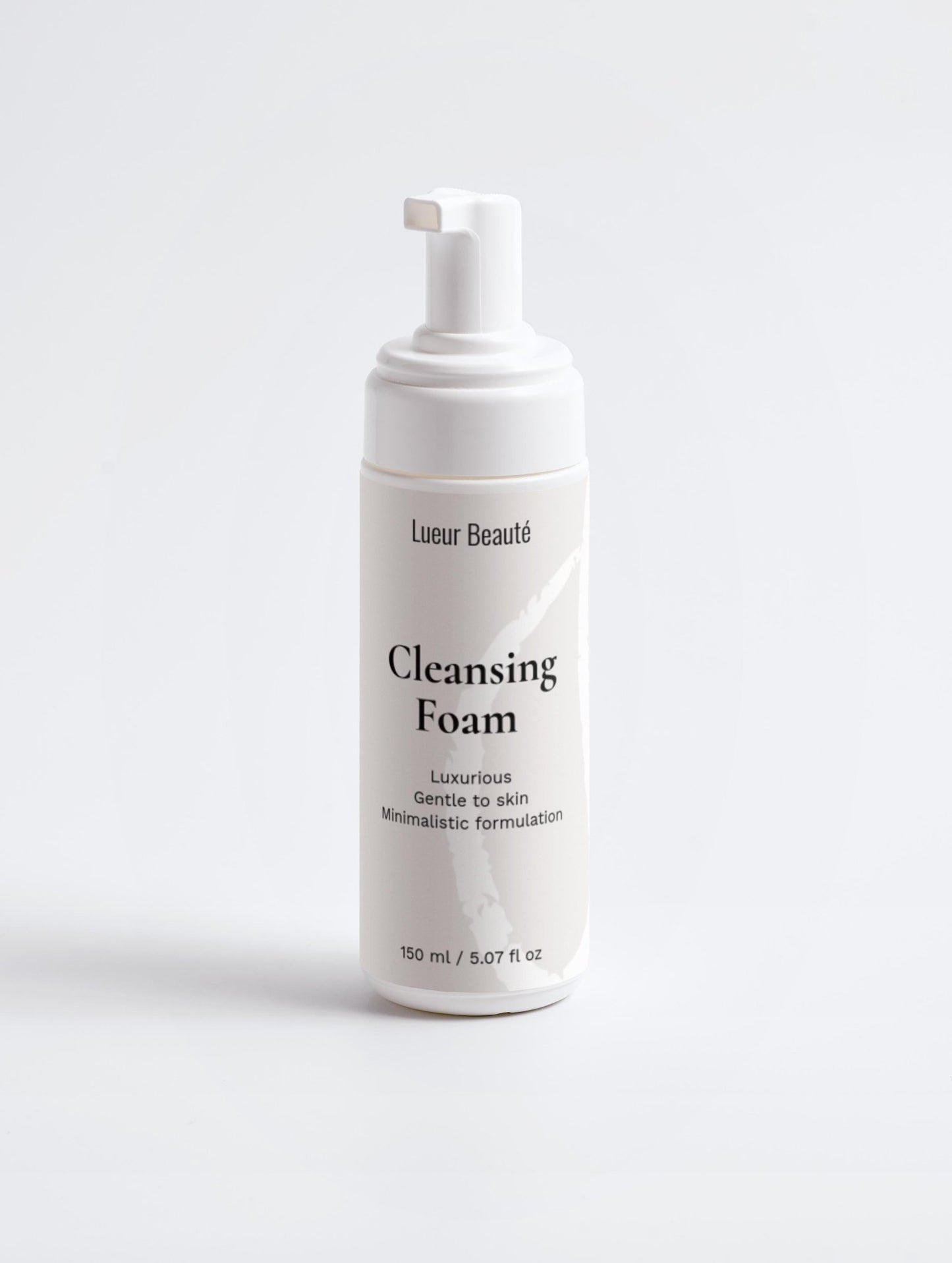 Cleansing foam bottle with pump on a white background