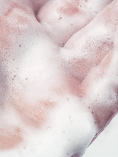 Cleansing foam creating soft bubbles in hand for gentle face cleansing and skin comfort