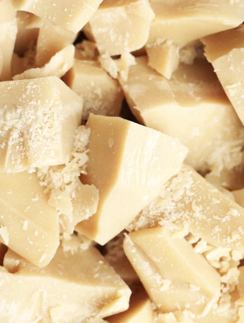 Natural cocoa butter pieces used in nourishing skincare formulations