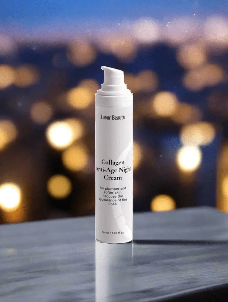 Lueur Beauté Collagen Anti-Age Night Cream bottle on a glossy marble surface with warm city bokeh lights in the background
