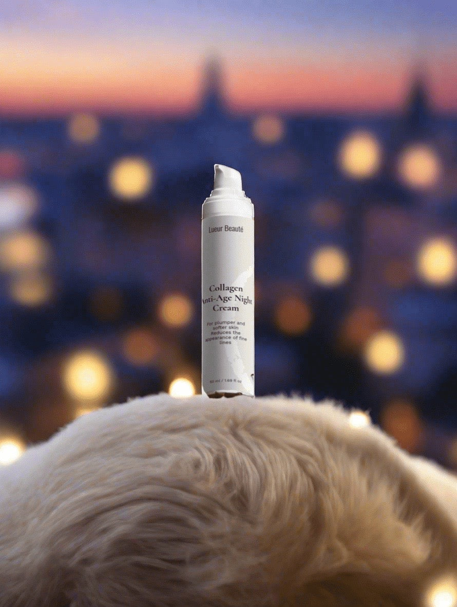 Lueur Beauté Collagen Anti-Age Night Cream standing on soft fur surface with warm bokeh lights in the background