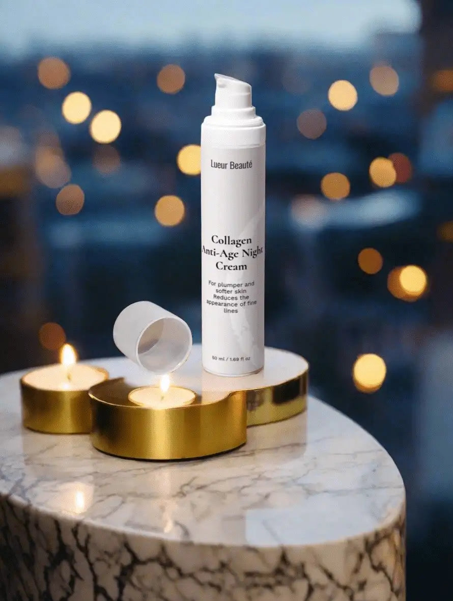 Collagen Anti-Age Night Cream by Lueur Beaute placed on marble table with candles and warm bokeh lights
