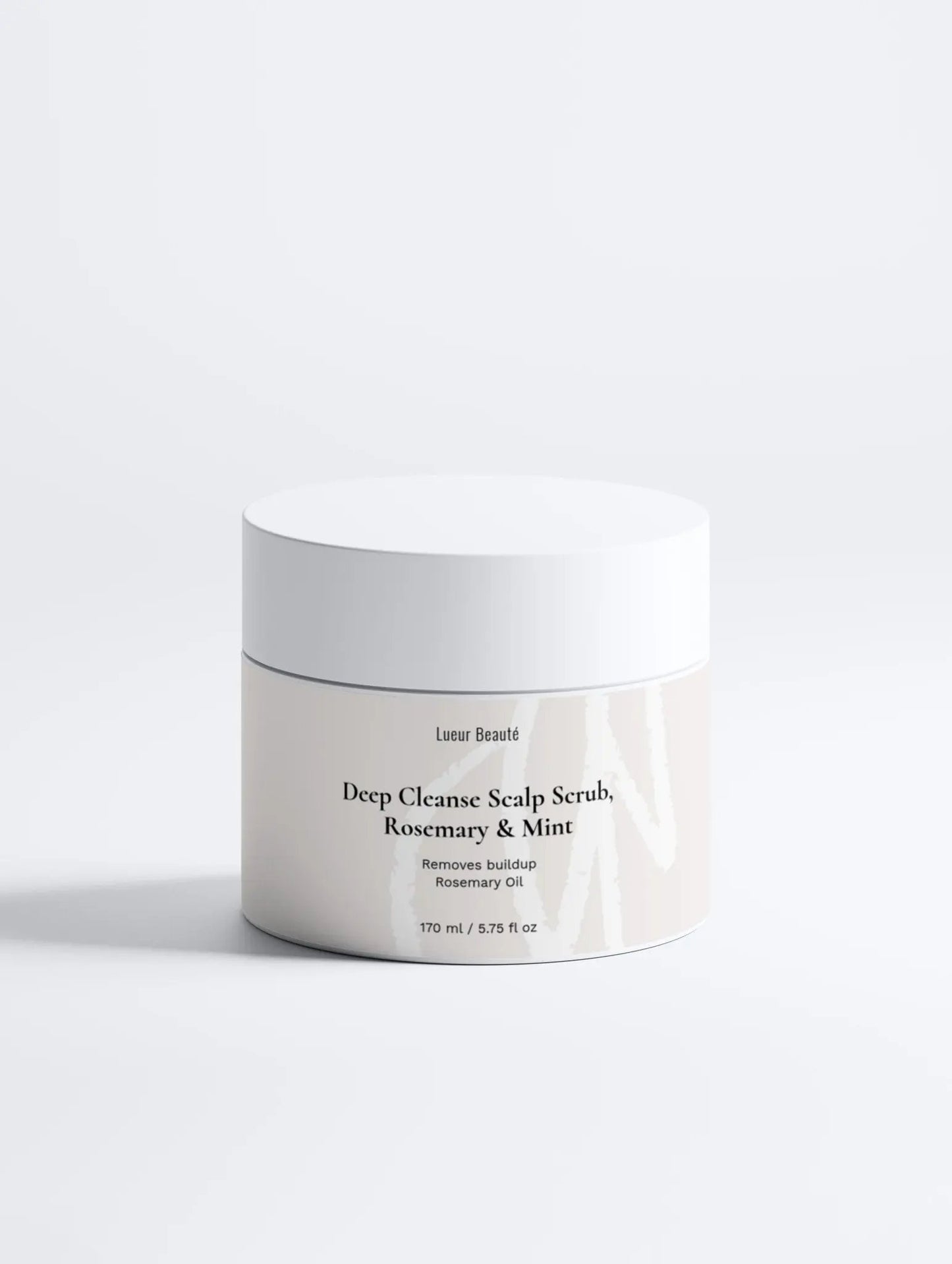 Lueur Beauté Deep Cleanse Scalp Scrub with rosemary and mint placed on a clean white background in a minimal studio setting.