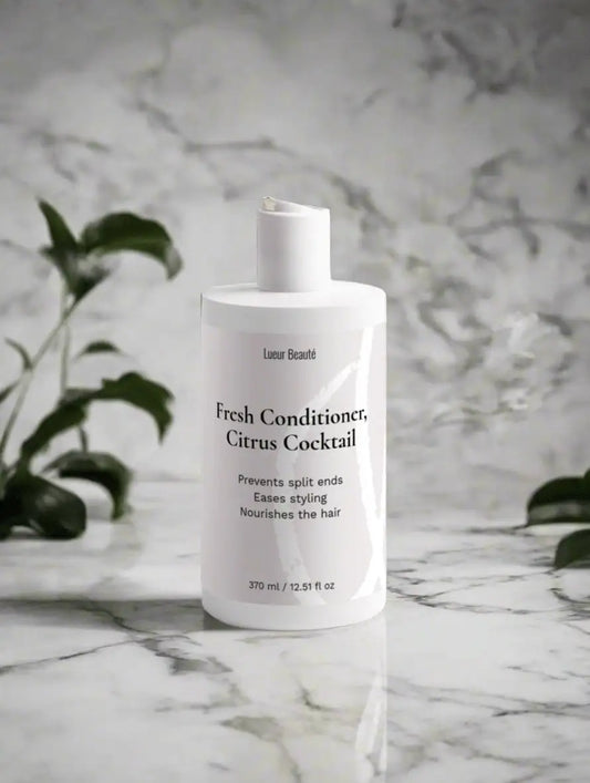Lueur Beauté Fresh Conditioner Citrus Cocktail standing on marble surface with soft botanical background