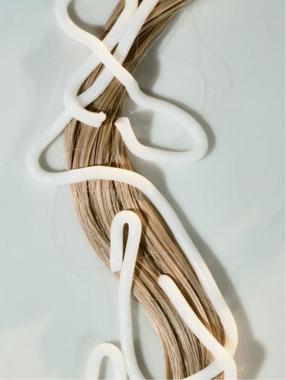 Gloss conditioner applied to hair for smoothness and shine