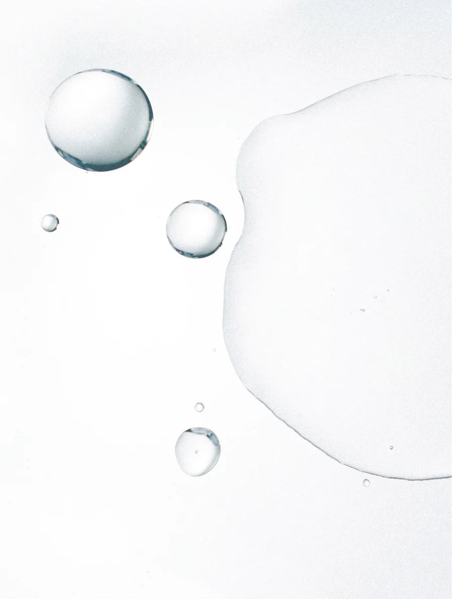 Glycolic acid exfoliating toner liquid texture representing gentle chemical exfoliation and skin renewal