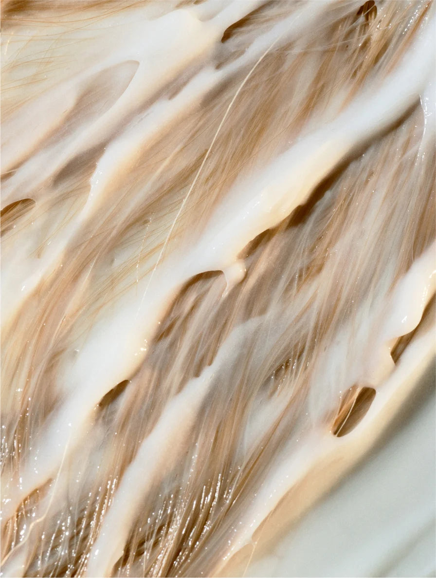 Keratin Volume Boost Conditioner texture applied on hair strands showing smoothing and volumizing effect