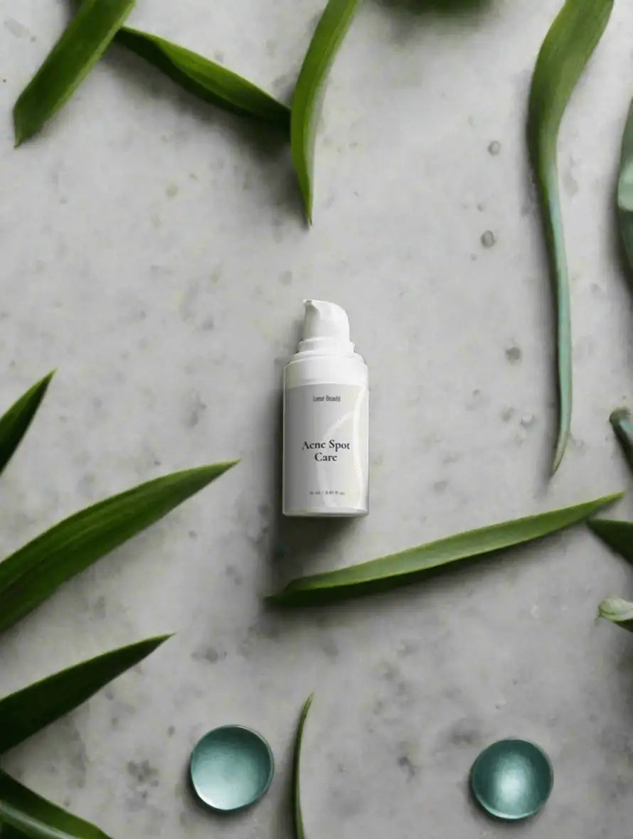 Lueur Beauté Acne Spot Care product on a natural green leaf background – targeted acne treatment skincare