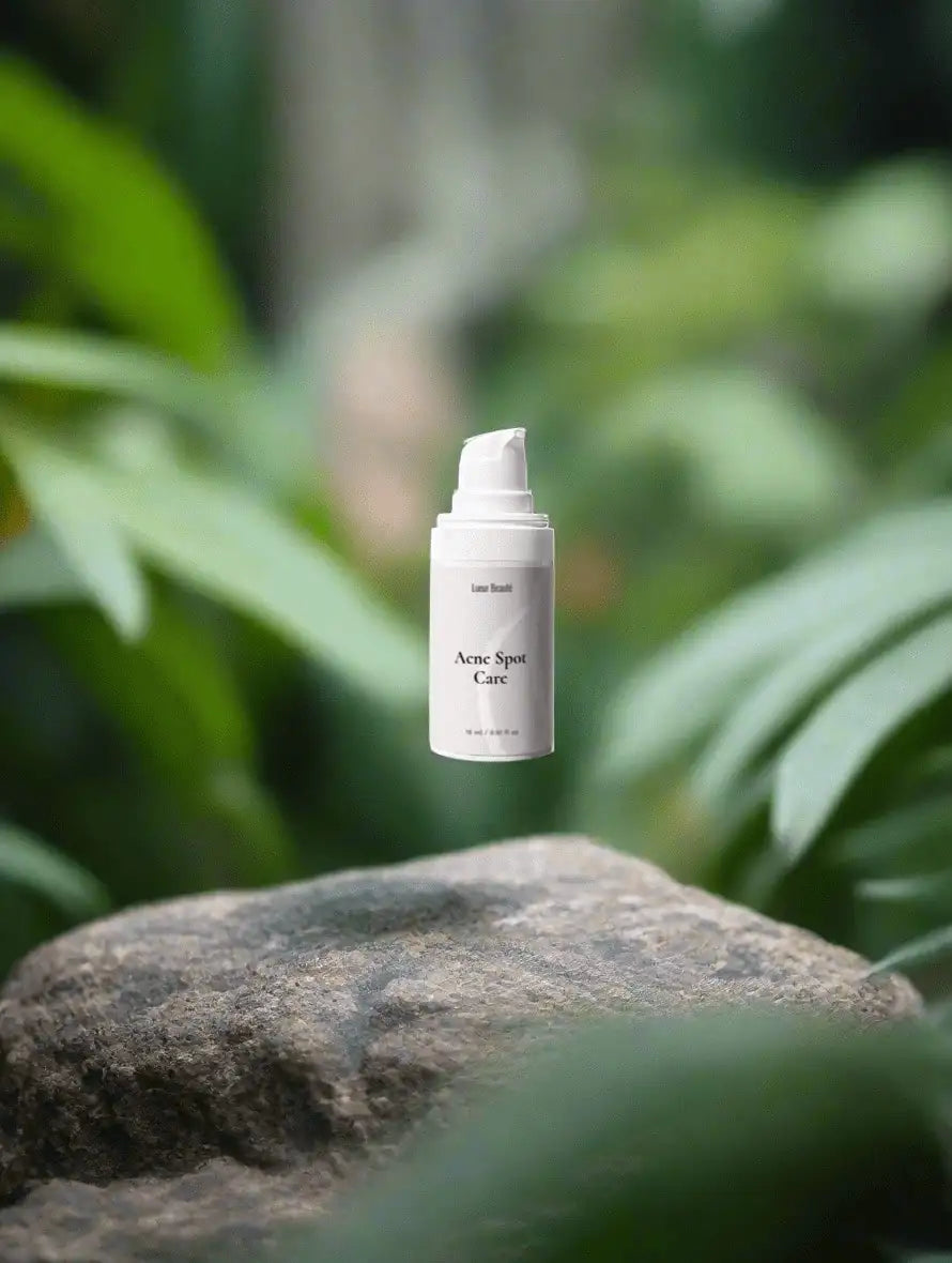 Lueur Beauté Acne Spot Care serum on natural stone with green botanical background – acne treatment skincare