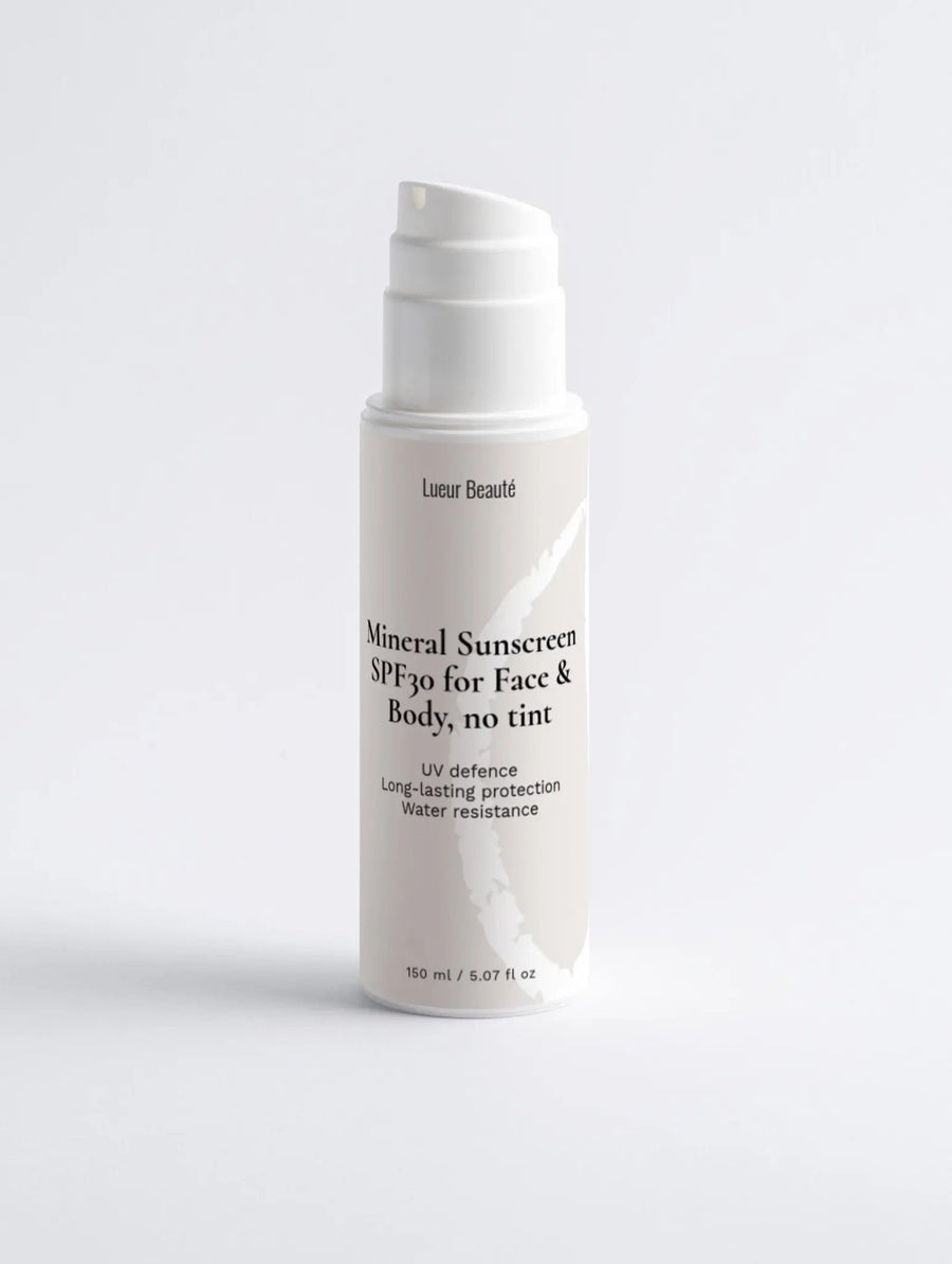 Lueur Beauté Mineral Sunscreen SPF30 bottle standing on a clean white background in a minimal studio setting.