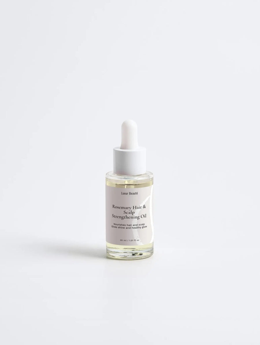 Lueur Beauté Rosemary Hair & Scalp Strengthening Oil bottle for hair growth and scalp nourishment.