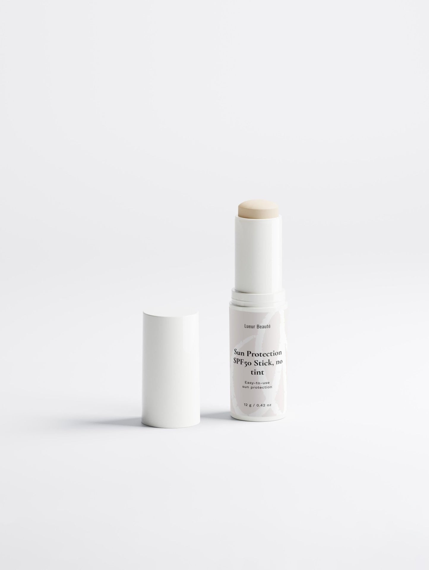 SPF50 sun protection stick with open cap standing on a clean white background