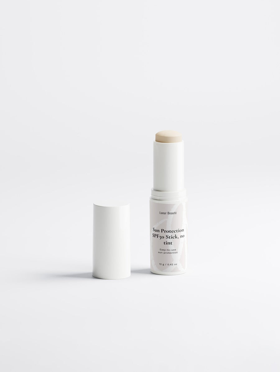 SPF50 sun protection stick with open cap standing on a clean white background
